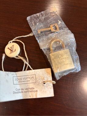 Louis Vuitton Gold Padlock in original packaging with LV staple too.